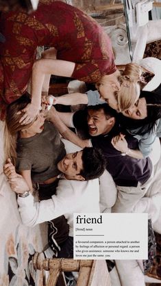 a group of people standing around each other in front of a sign that says friend