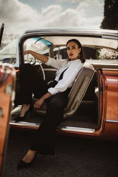 a woman sitting in the back seat of a car