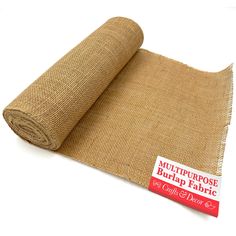 a roll of burlap fabric sitting on top of a white surface with a red sticker