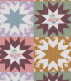 a multicolored patchwork quilt with stars and flowers