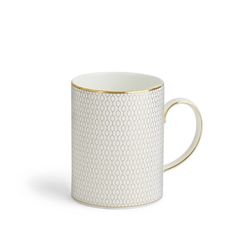 a white and gold coffee cup on a white background