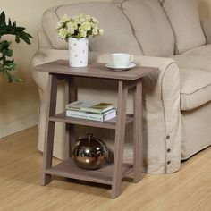 a coffee table with a vase on it next to a couch