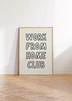 a framed poster that says work from home club on the wall next to a wooden floor