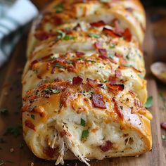 the bread is covered with bacon and cheese