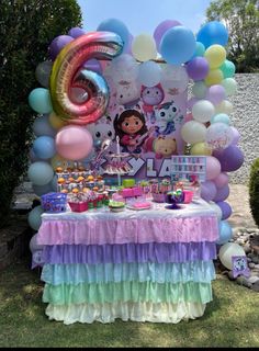 an outdoor birthday party with balloons, cake and decorations