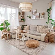 a living room filled with lots of furniture and plants on top of a rug in front of a window