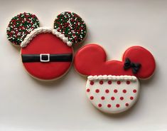 mickey mouse and minnie mouse cookies decorated to look like santa's helper hats