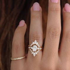 a close up of a person's hand with a ring on it and a diamond in the middle