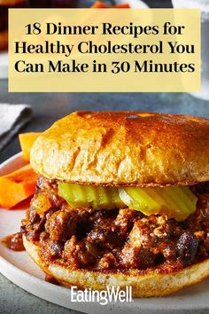 a sloppy joe sandwich on a plate with carrots and ketchup