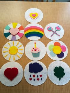 felt craft kits laid out on top of a table with different shapes and colors in them