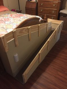 a bed with two drawers on each side and an open drawer in the middle for storage