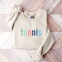 Tennis Sweatshirt for Women Tennis Sweater Preppy Sweatshirt Tennis Gifts for Women Tennis Apparel Tennis Mom Gift Preppy Tennis Sweater PRODUCT DETAILS 50% cotton, 50% polyester Unisex, crewneck sweatshirt Pre-shrunk, air-jet spun yarn Image & text are printed with ink (DTG printing) Gildan brand SIZING Unisex sizing Please refer to the size chart in listing images to ensure correct fit Size up for a slouchier fit CARE INSTRUCTIONS Machine wash cold, inside-out, gentle cycle Use mild detergent Sporty Multicolor Cotton Sweatshirt, Sporty Multicolor Crew Neck Sweatshirt, Multicolor Crew Neck Sweatshirt For Sports, Sporty Multicolor Cotton Sweater, Sporty Multicolor Top With Ribbed Cuffs, Multicolor Cotton Sports Sweatshirt, Sporty Multicolor Letter Print Sweatshirt, Yarn Images, Tennis Sweater