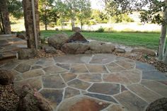 a stone walkway in the middle of a grassy area