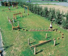 an aerial view of a park with children playing in the grass