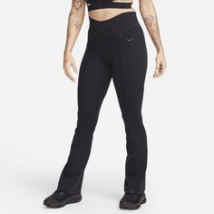 a woman in black sports bra top and leggings standing with her hands on her hips