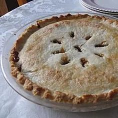 a pie sitting on top of a white table cloth