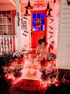 a halloween porch decorated with pumpkins and decorations