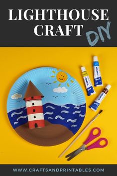 a paper plate with an image of a lighthouse on it and some craft supplies next to it