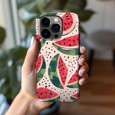 a woman holding up her phone case with watermelon slices on it