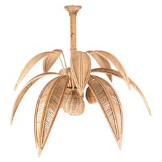 a wooden chandelier with three large leaves hanging from it's center point