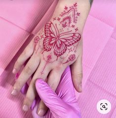 a woman's hand with a butterfly tattoo on it