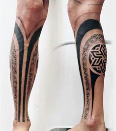 a man's leg with tattoos on it and an intricate design in the middle