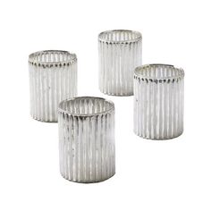 three silver vases sitting next to each other