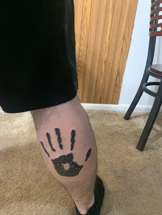 a man's leg with a hand print on it