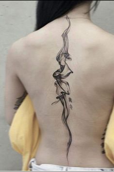 the back of a woman's body with tattoos on it