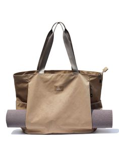 a large beige bag sitting on top of a yoga mat