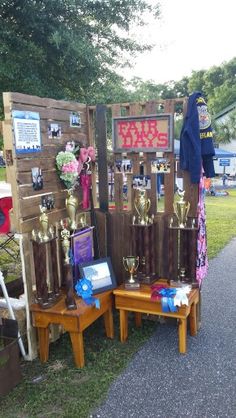 an outdoor display with trophies and other items