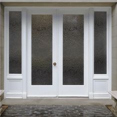 a white double door with glass on the outside