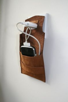 a cell phone in a pouch attached to a wall