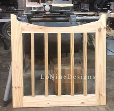 an unfinished wooden gate is shown in front of a workbench at a factory