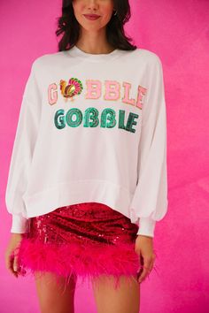 Show off your holiday spirit with this GOBBLE GOBBLE White Pullover! This lightweight cropped top is sure to get you in the Thanksgiving mood with its pink and green sequin Gobble Gobble text, and a feathered turkey patch sure to put a smile on your turkey-lovin' face. Feel cozy and festive all at once! Gobble 'til you wobble! This is a made-to-order item. All customized orders are currently shipping within 14 business days. To receive item quicker, expedited shipping is available at checkout. S Fall Sequin Long Sleeve Sweatshirt, Sequin Long Sleeve Sweatshirt For Fall, Sequined Long Sleeve Fall Sweatshirt, Gobble Til You Wobble, White Pullover, Gobble Gobble, Green Sequins, Cropped Top, Holiday Spirit