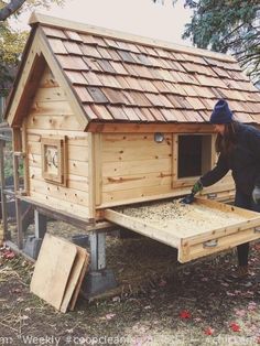 a woman is building a chicken coop in the yard