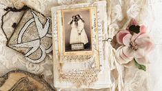 an old photo and some other items on a lace tablecloth with flowers in the corner