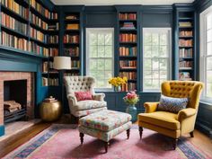 a living room filled with furniture and bookshelves full of bookcases next to a fire place