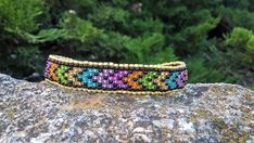 Loom Beaded Cuff Bracelet with Native American Style Arrows pattern in colorful glossy colors designed by myself. Made out of Czech seed beads and a lobster clasp.    This bracelet measures 19 cm or 7.5 inches and is 1,4 cm or 0,55 inches wide.  Color and size can be changed up to order! When ordering, please choose your wrist circumference from the drop-down options or write me a short message about your ankle or hand wrist circumference. I want my products to fit you well! Please be patient an Multicolor Faceted Beads Friendship Bracelets, Multicolor Faceted Beads Bracelet For Festival, Multicolor Faceted Beaded Bangle Bracelet, Multicolor Cuff Bracelet With Colorful Beads, Multicolor Cuff Bracelet With Round Colorful Beads, Multicolor Round Beads Cuff Bracelet, Loom Bead Bracelet, Bracelet Loom, Bead Loom Bracelet