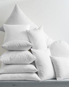 white pillows stacked on top of each other