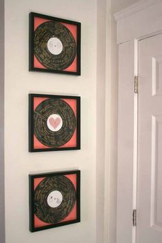 three framed records are hanging on the wall