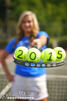 a woman holding a tray with tennis balls in the shape of 2012 and 2013 on it