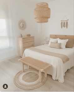 a bed room with a neatly made bed and wooden furniture