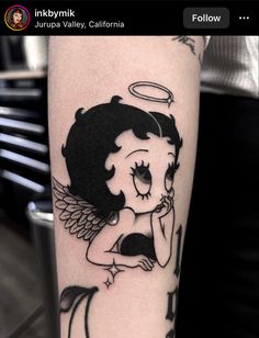 a woman with an angel tattoo on her arm