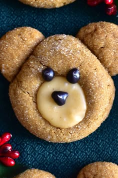 some cookies with icing on them are shaped like a teddy bear's face