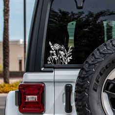 a white truck parked on the side of a road next to a tall palm tree