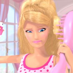 a barbie doll is brushing her hair with a pink brush