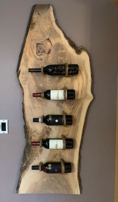 a wall mounted wine rack with six bottles