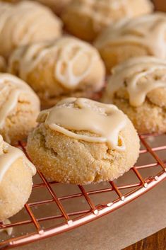 some cookies with icing sitting on a cooling rack