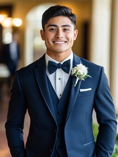 a young man in a tuxedo smiles for the camera while wearing a boutonniere